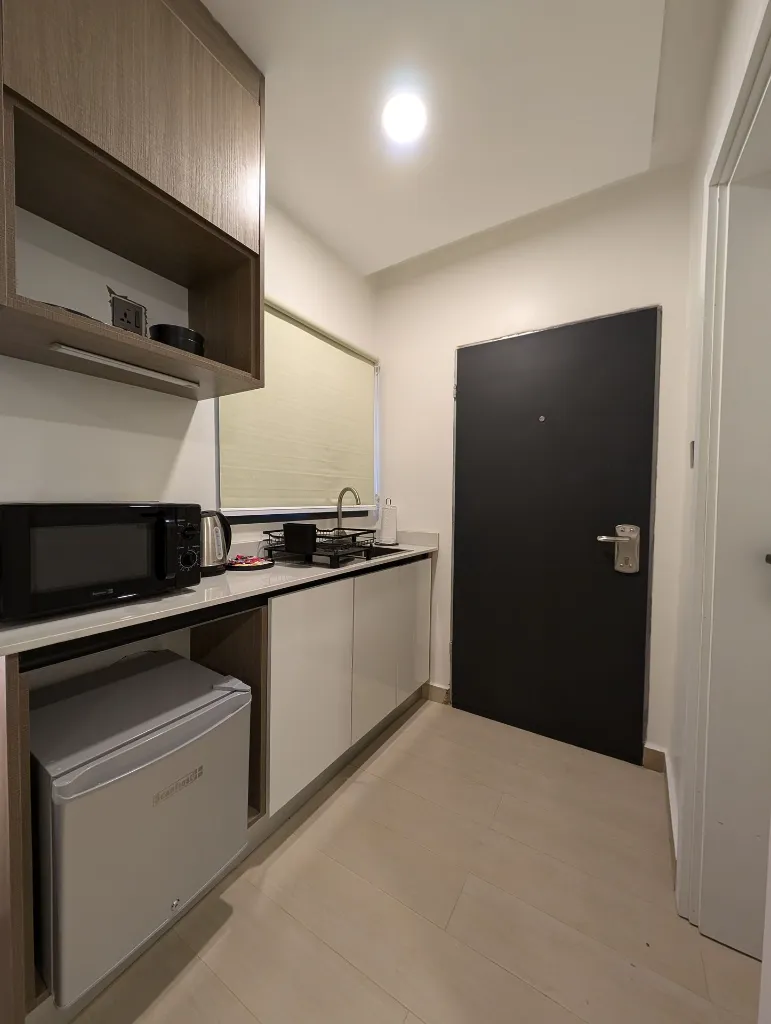 Room 202 Kitchenette and Balcony door view.webp