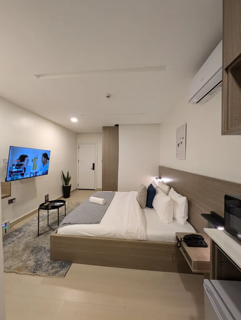 Room 203 Bedroom and entrance door view.webp